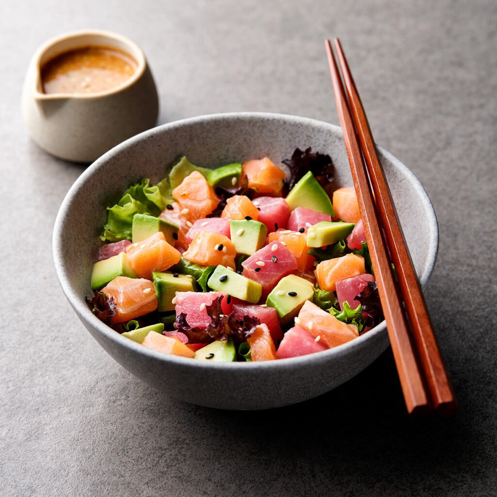 Poke Bowl with raw salmon, tuna and avocado in japanese restaurant in Dubai by food photographer Dubai